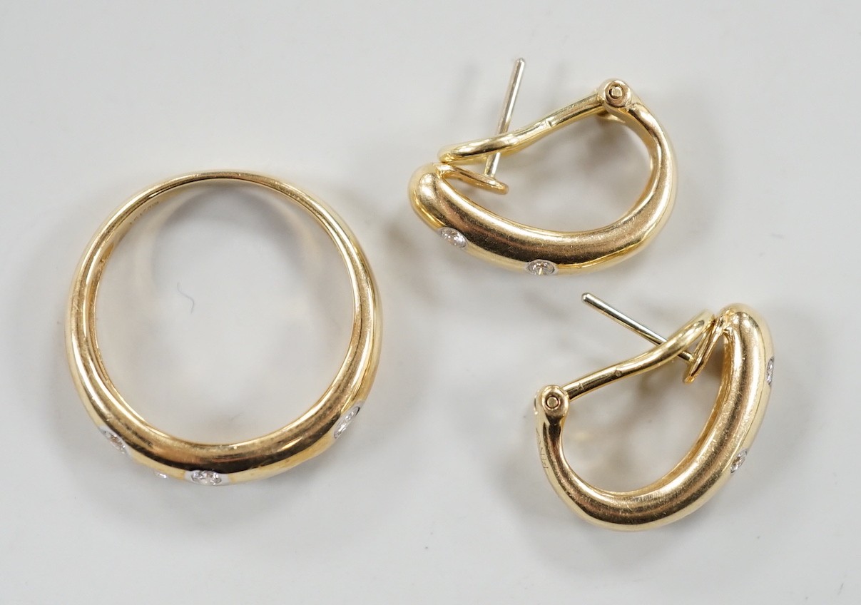 A modern 14k and gypsy set six stone diamond band, size N and a pair of matching earrings, gross weight 8.1 grams.